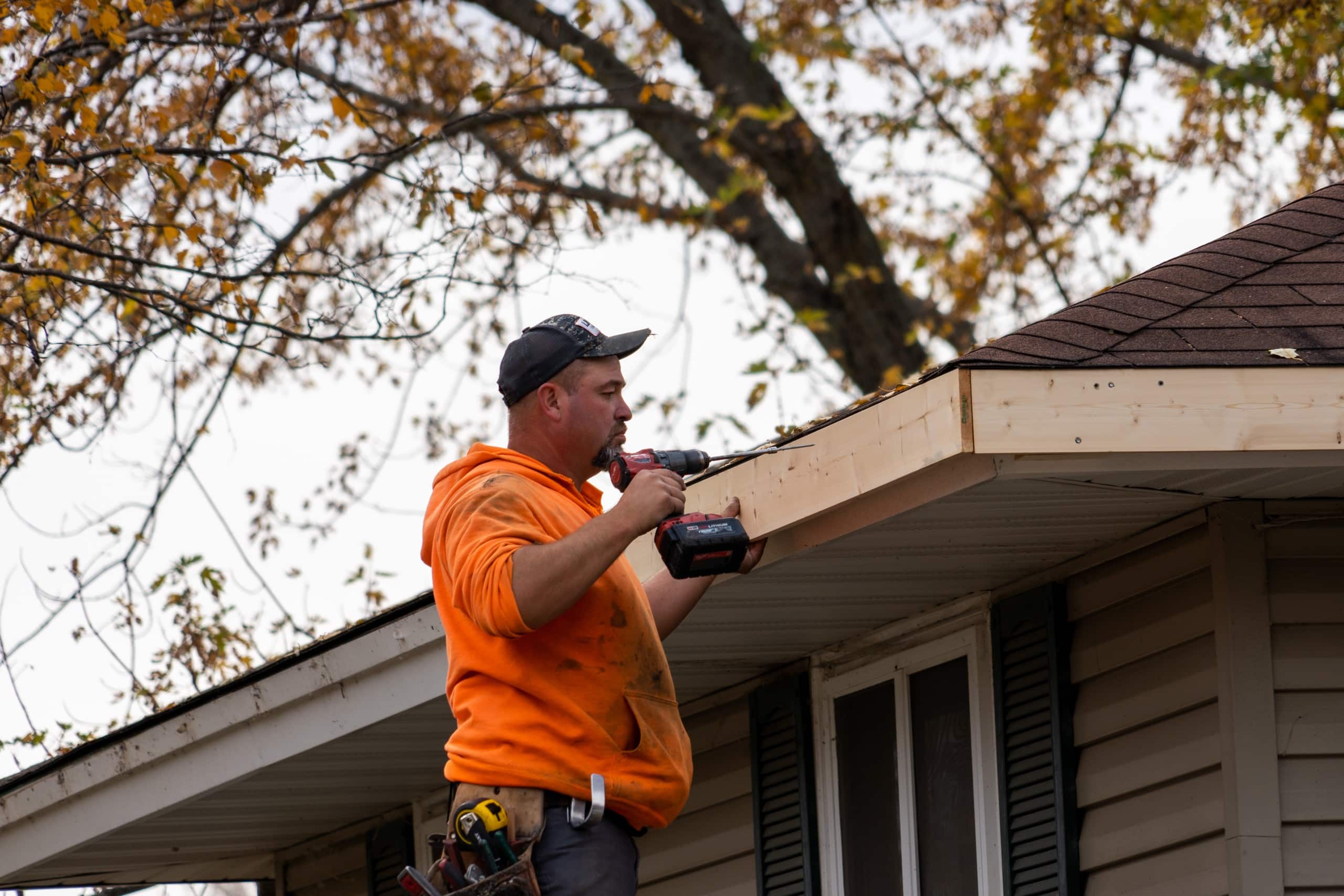 A gutter installation by Lindus Construction on a home in the fall.
