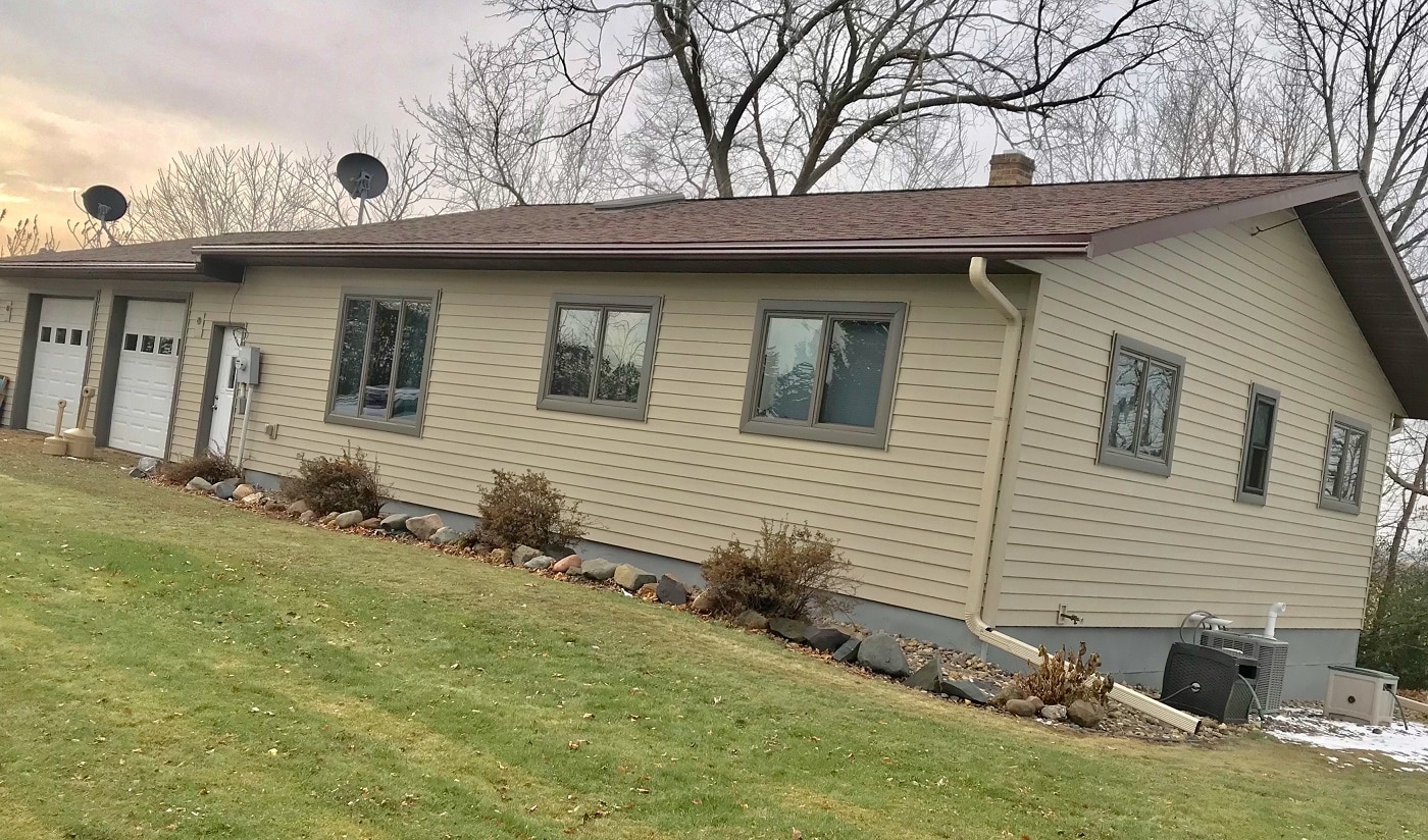 new tan steel siding installed on Downing home