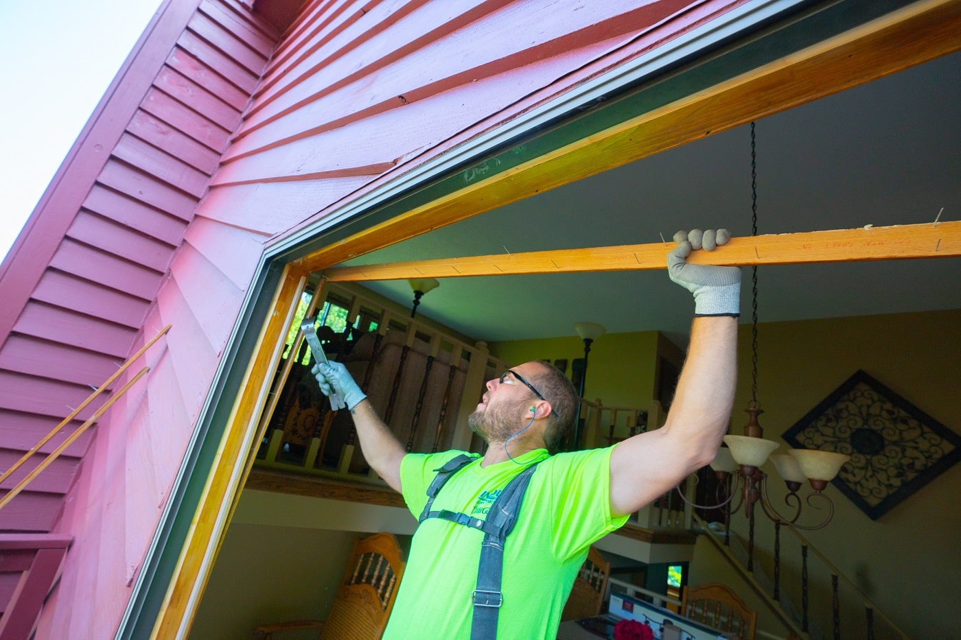 contractor installing replacement window