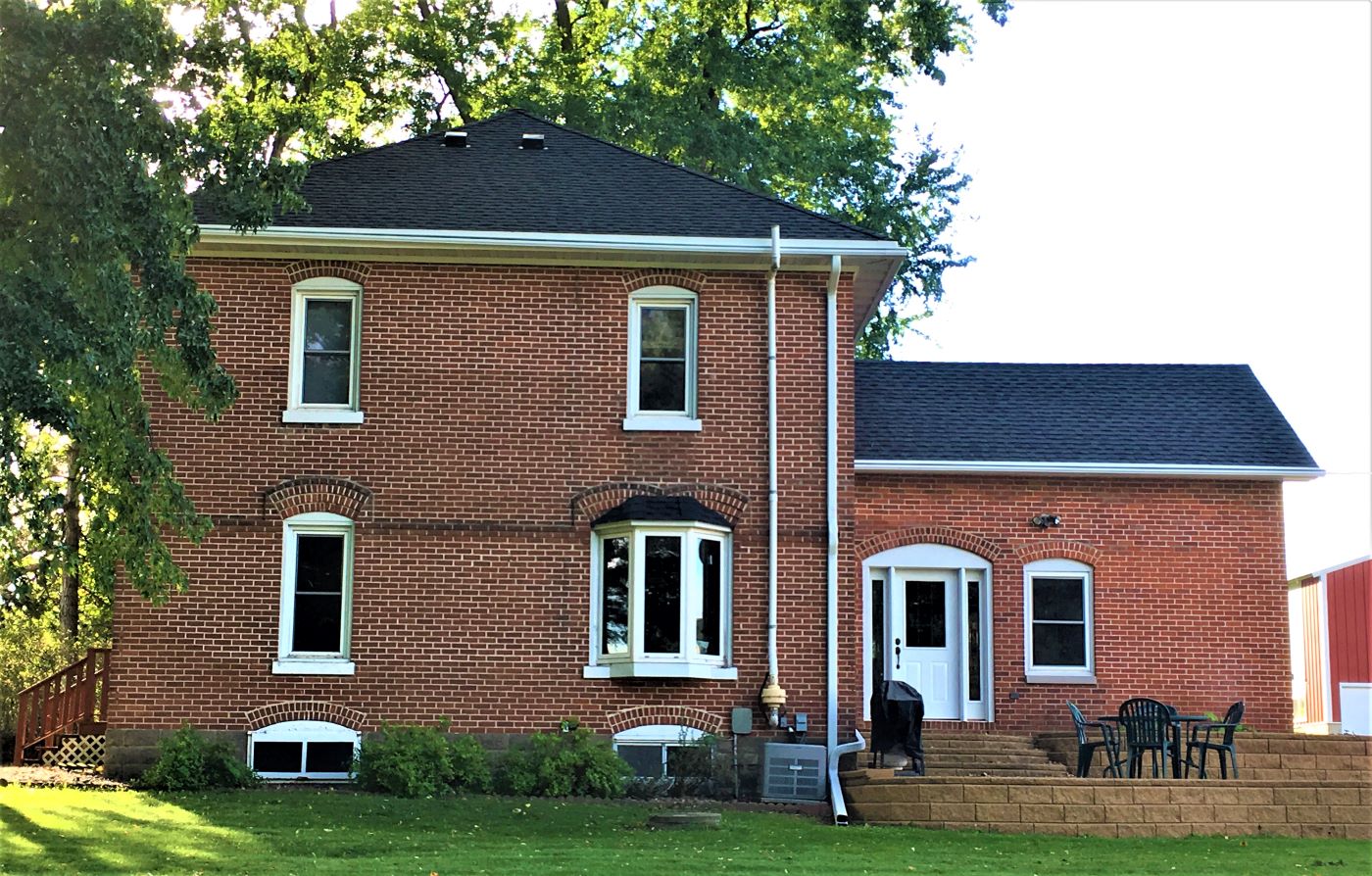 Bloomer brick house with newly installed roofing and gutters