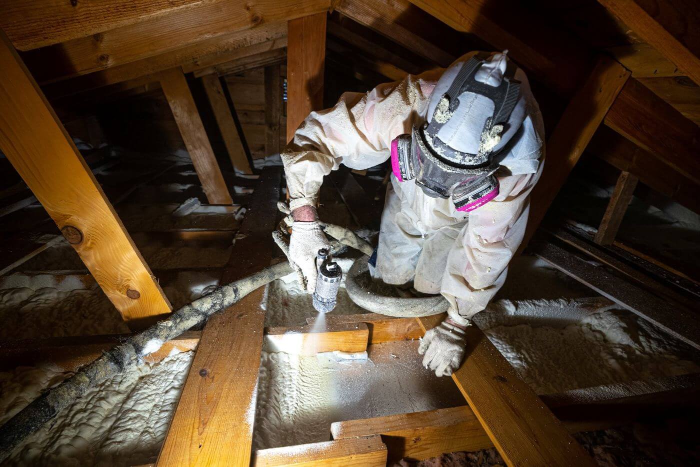 Technician Applies Spray Insulation in Attic